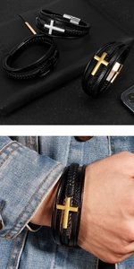 Detailed view of multilayer black leather bracelets with gold and silver cross charms