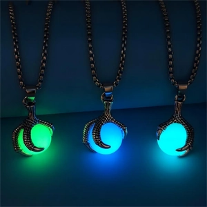 Luminous dragon claw pendants glowing in green, cyan, and blue within dark settings