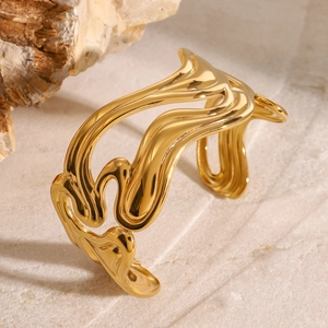 Modern wide open cuff bracelet in 18k gold plated stainless steel with fluid wavy design