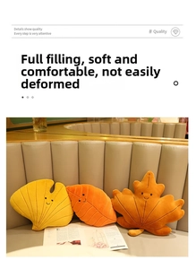 Detailed embroidery of smiling faces on plush leaf-shaped pillows for home decoration