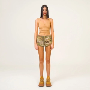 Women's camouflage cargo shorts and tan ribbed tank top in a full studio shot