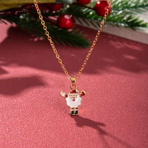 Detailed view of enamel Santa Claus pendant on gold chain with festive red background