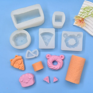 Silicone molds for cake and donut shapes with finished DIY resin crafts on blue background