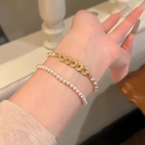 Elegant Chinese style pearl bracelet with golden coin charms and sparkling zircon inlay