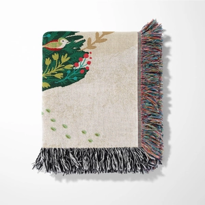 Detailed close-up of bohemian woven throw blanket with bird pattern and colorful tassels