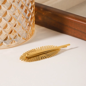 Golden sunburst stainless steel hair clip with pearl accents for elegant hair styling
