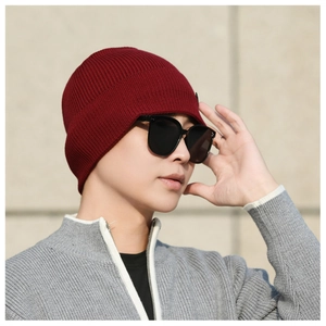 Close-up of deep red ribbed knit beanie with thermal lining for winter outdoor warmth