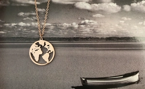 Detailed close-up of rose gold hollow world map necklace pendant with o-link chain design