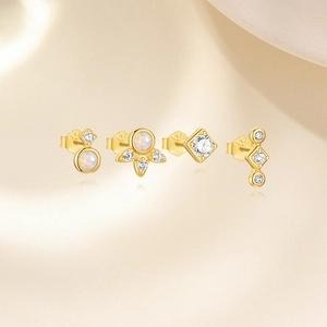 Detail of four-piece S925 silver stud earring set with opal and zircon in gold finish