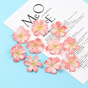 Detailed macro view of 11 artificial pink cherry blossom heads for DIY hair accessories