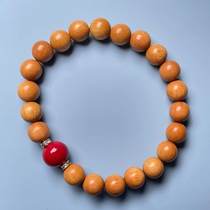 Macro view of sandalwood beads bracelet with red accent bead and zircon spacers