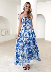 Detail of blue and white floral long dress with ruffled bodice and bow straps