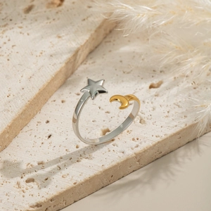 Elegant star and moon open ring in silver and gold stainless steel on stone