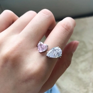 Detail of S925 silver Toi et Moi ring featuring pink heart and white pear gemstones