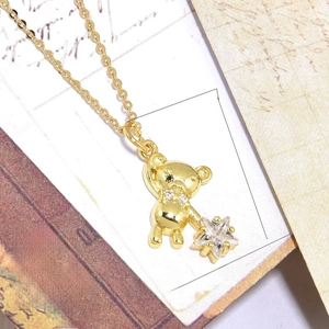Close-up of 18k gold plated bear pendant with sparkling zircon star and O-chain necklace