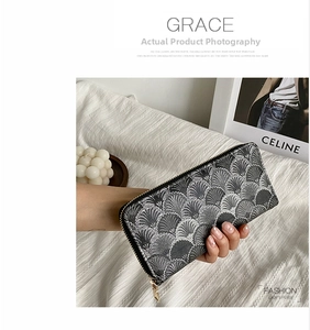 Detail of long wallet showing intricate black and white fan-shaped jacquard texture