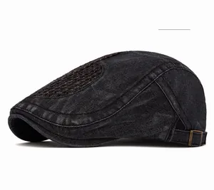 Detail of vintage washed black denim newsboy cap with top stitching and bronze buckle