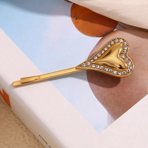 Macro view of 18K gold plated heart hair clip with sparkling crystal edge details