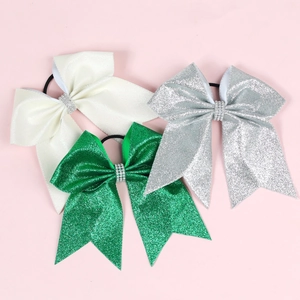 Detailed view of glitter bow hair ties with rhinestones in white, green, and silver colors