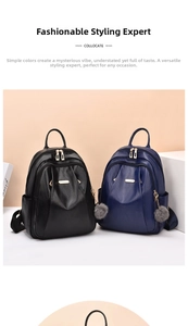 Detail view of black and navy PU leather backpacks with lychee texture and gold accents