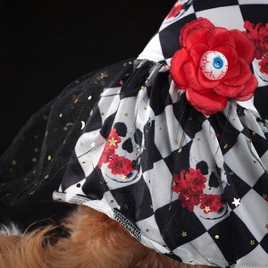 Close-up of Halloween pet hat with red rose, blue eyeball, and black star sequin veil