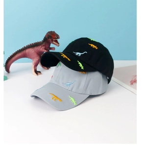 Close-up of colorful dinosaur embroidery on black and grey children's baseball caps