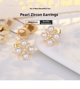 Detailed macro shot of four-petal flower earrings with white pearls and AAA zircons