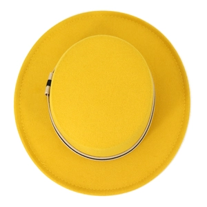 Detail view of bright yellow wool fedora hat with flat crown and beige decorative band