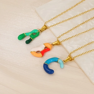 Detail of colorful enamel bubble letter pendants A B C on gold plated necklaces