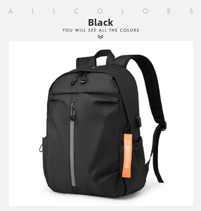 Detail of black laptop backpack with USB port, reflective zipper, and orange tag