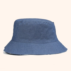 Classic reversible denim bucket hat with coconut tree pattern and fine stitching details