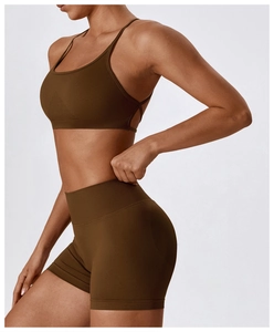 Macro shot of seamless high-waist yoga shorts and strappy back sports bra detail
