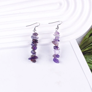 Close-up of handmade natural purple amethyst stone beads on silver hook earrings