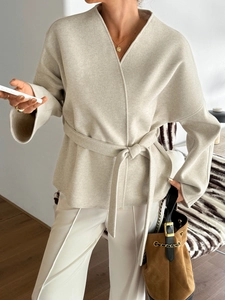Detail view of a beige belted blazer for women made of premium wool blend fabric