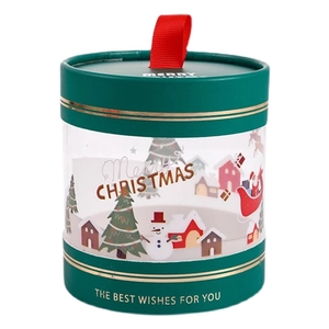 Green cylindrical Christmas gift box with transparent window and red handle for candies