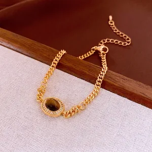 Gold plated Cuban chain bracelet with oval tiger eye stone and zircon crystals