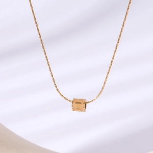 18k gold plated round necklace with hollow heart pendant on soft white fabric