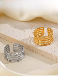 Detailed macro of 18K gold plated 5-layer open rings with hammered texture