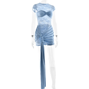 Detail of blue lace patchwork dress with side ribbon and elegant ruffled hip design