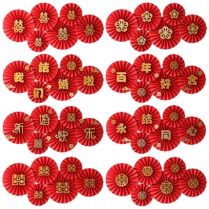 Detail of red wedding paper fans with gold Chinese characters for festive party decor