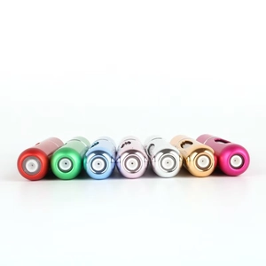 Close-up of seven colorful refillable 5ml aluminum perfume spray bottles on white background