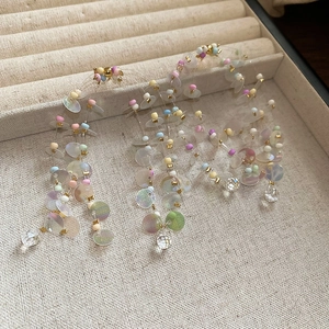 Macro view of colorful beaded tassel earrings with iridescent sequins and crystal drops