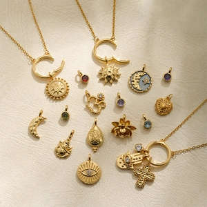 18K gold chain necklaces with celestial pendants, sun, moon and Hamsa hand charms