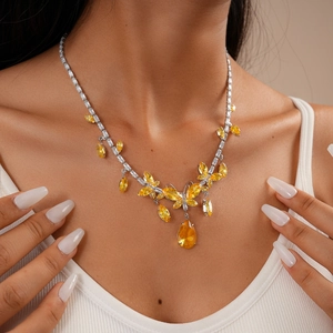 Detail showing vintage butterfly necklace with yellow waterdrop pendant on neck