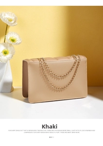 Detail of khaki crossbody bag with vertical quilted texture and gold chain straps
