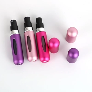 Three refillable perfume spray bottles in purple and pink with transparent windows