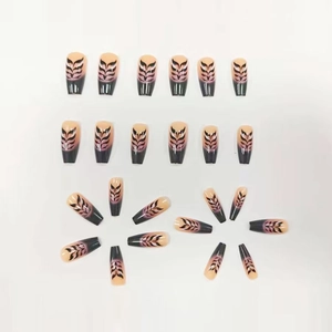 Glossy ombre press-on nails with black flame patterns and long coffin shape
