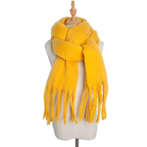 Detailed close-up of yellow mohair scarf with soft texture and long decorative tassels