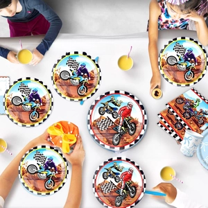 Detailed view of motocross theme party paper plates and cups for boys birthday decor