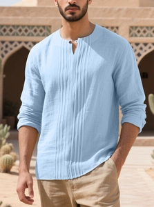 Close-up of light blue cotton linen shirt showing textured fabric and button collar detail